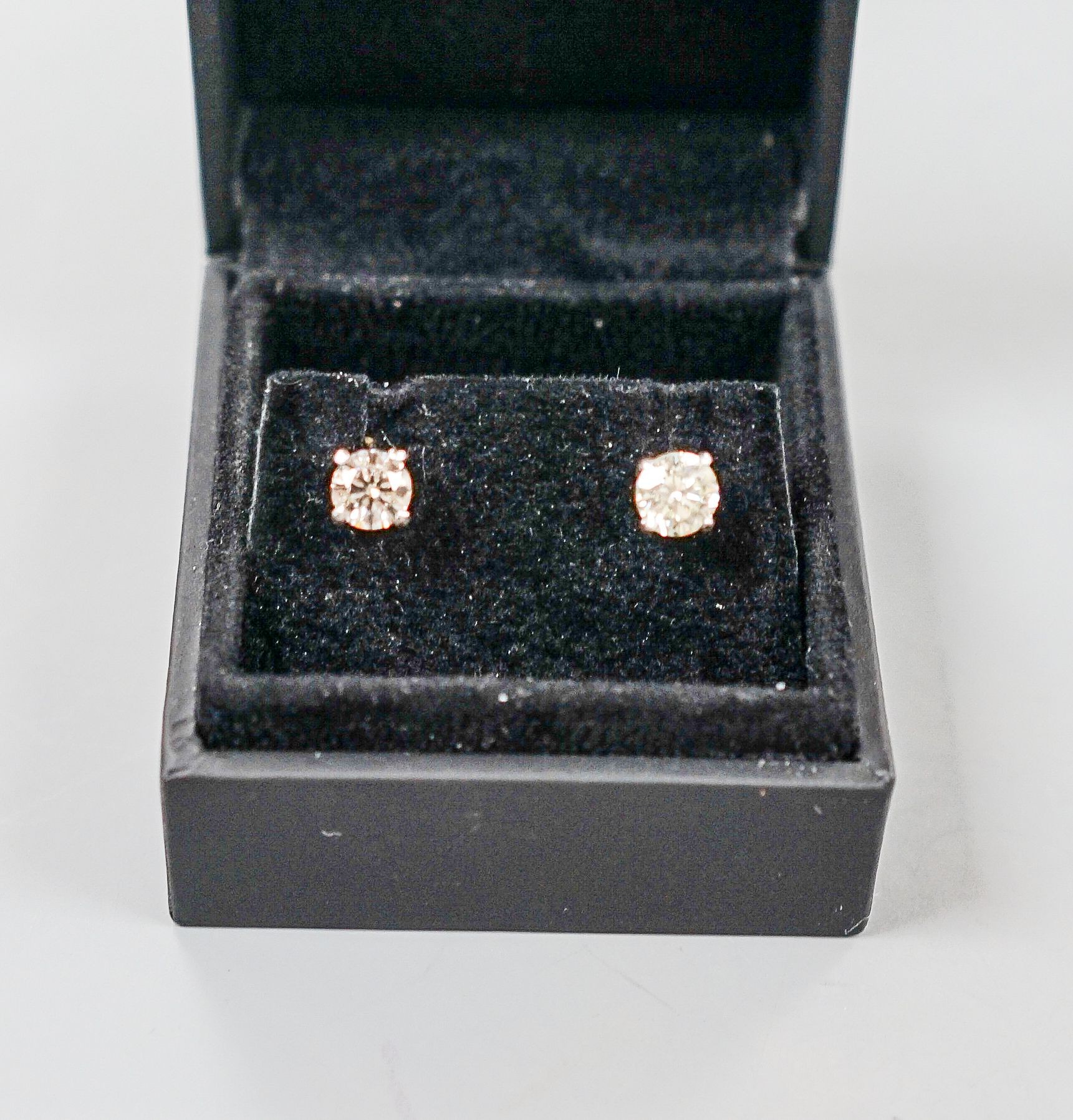 A pair of 750 white metal and solitaire diamond ear studs, gross weight 2.3 grams